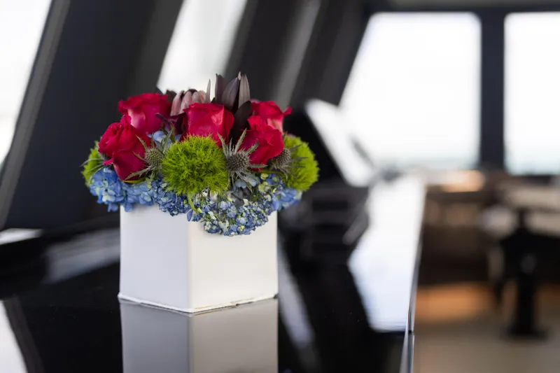 Slide: The Image of Floral arrangement on Sunreef 68 Supreme yacht, 2018 model, featuring vibrant red and green flowers. - 39