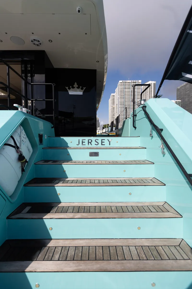Slide: The Image of Staircase leading to Sunreef 68 Supreme yacht, 2018 model, with city skyline in background. - 40