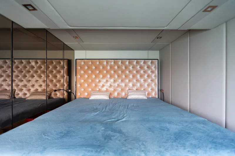 Slide: The Image of Luxurious bedroom interior on 2018 Sunreef 68 Supreme yacht with tufted headboard and mirrored walls. - 48