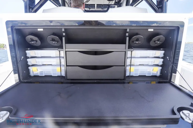 Slide: The Image of 2023 Fountain 38 TE storage compartment with organized tackle boxes. - 27
