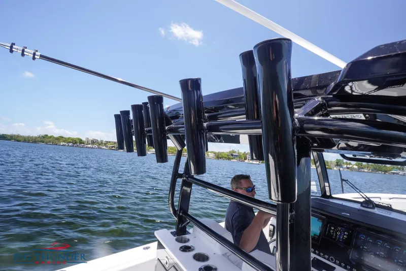 Slide: The Image of 2023 Fountain 38 TE boat on water with rod holders and console. - 29