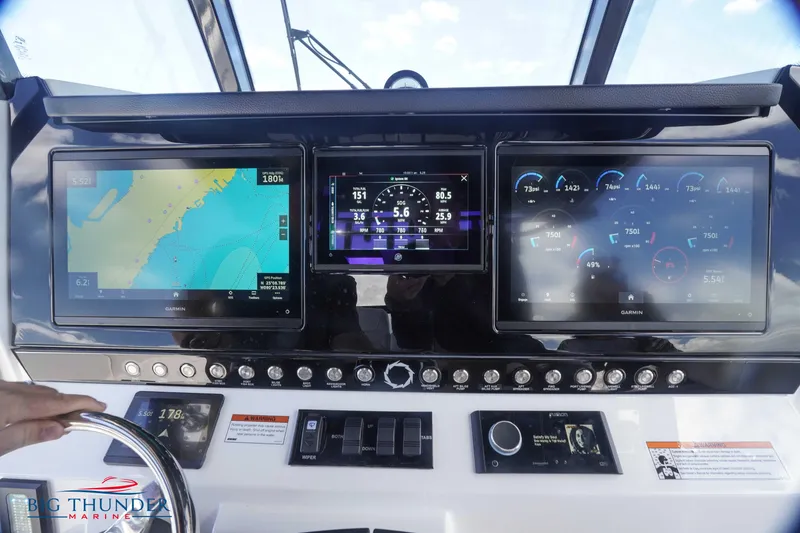 Slide: The Image of Control panel of 2023 Fountain 38 TE boat with navigation and engine displays. - 30