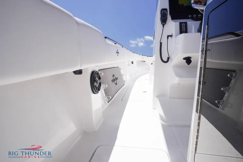 Slide: The Image of 2023 Fountain 38 TE boat interior with white deck and Big Thunder Marine logo. - 39