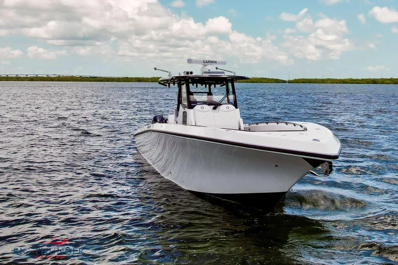 Slide: The Image of 2023 Fountain 38 TE boat cruising on open water under a partly cloudy sky. - 4