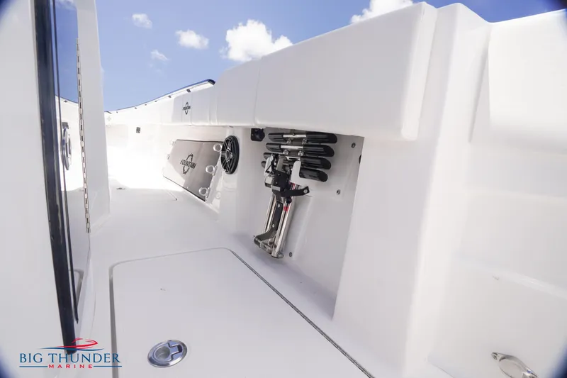 Slide: The Image of 2023 Fountain 38 TE boat interior with storage compartments and Big Thunder Marine logo. - 43