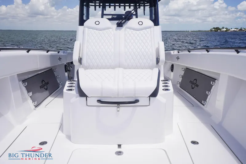 Slide: The Image of 2023 Fountain 38 TE boat interior with white seating and ocean backdrop. - 46