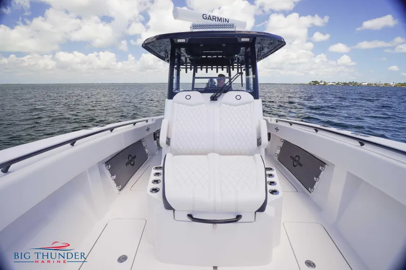 Slide: The Image of 2023 Fountain 38 TE boat interior with white seating on open water. - 47
