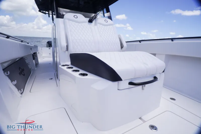Slide: The Image of 2023 Fountain 38 TE boat interior with white seating and ocean backdrop. - 48