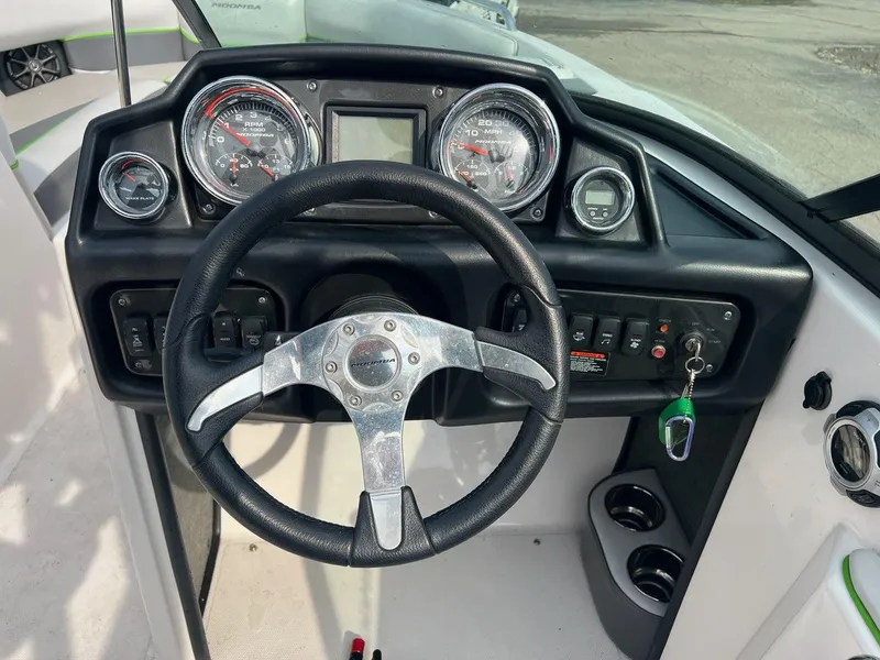 Slide: The Image of 2014 Moomba Mojo 2.5 boat dashboard with steering wheel and gauges. - 6