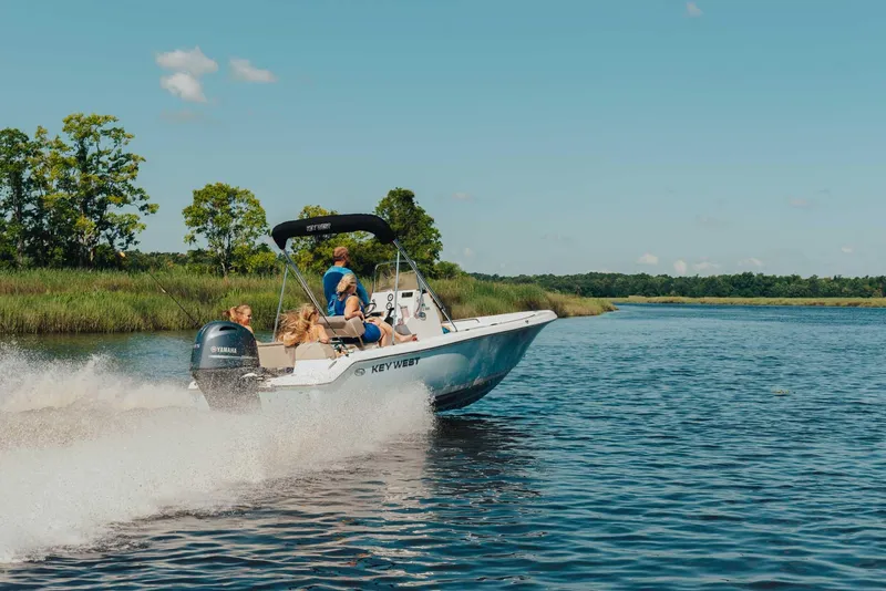 Slide: The Image of 2026 Key West 189 FS boat interior with cushioned seating and modern design. - 16