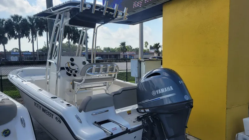 Slide: The Image of 2026 Key West 189 FS boat with Yamaha 115 engine on display at dealership. - 2