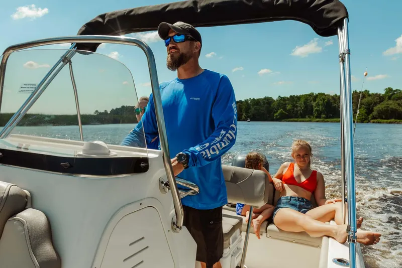 Slide: The Image of 2024 Key West 189 FS boat cruising on a lake with passengers. - 23