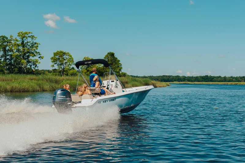 Slide: The Image of 2024 Key West 189 FS boat cruising on a lake with passengers. - 24