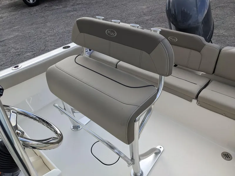 Slide: The Image of 2026 Key West 189 FS boat interior with cushioned seating and Yamaha outboard motor. - 6