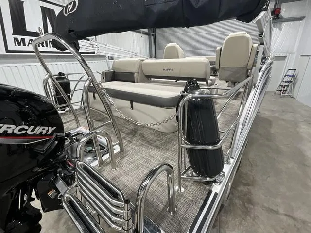 Slide: The Image of 2023 Harris Cruiser 230 pontoon boat with Mercury engine in a showroom. - 12