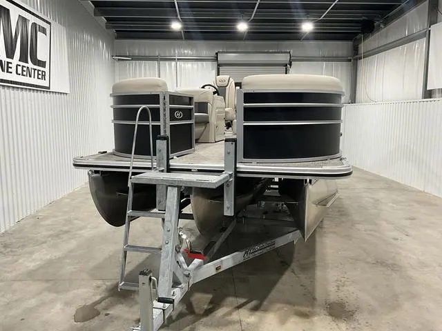 Slide: The Image of 2023 Harris Cruiser 230 pontoon boat in indoor storage facility. - 3