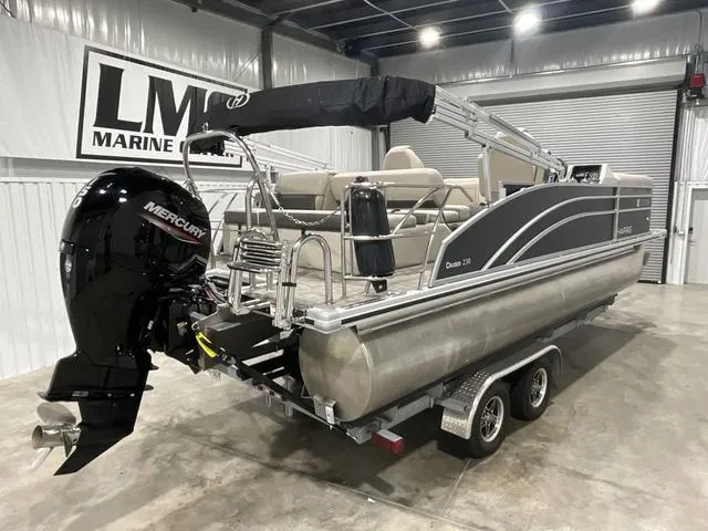 Slide: The Image of 2023 Harris Cruiser 230 pontoon boat with Mercury engine in a showroom. - 4