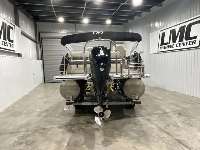 Slide: The Image of 2023 Harris Cruiser 230 boat in a showroom at LMC Marine Center. - 5