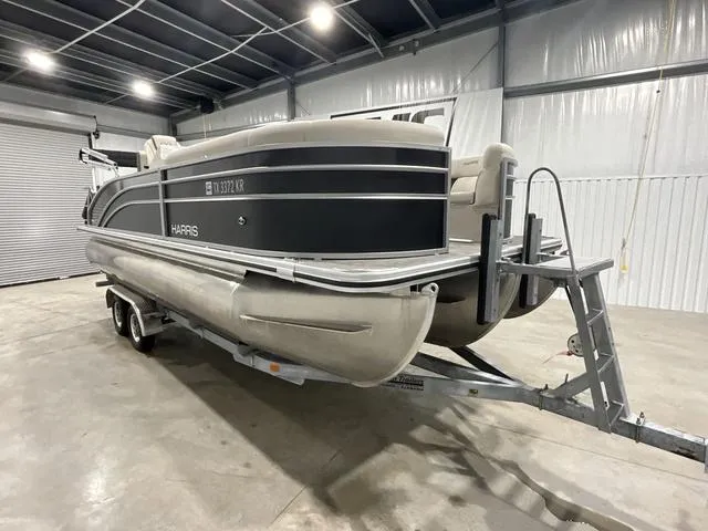Slide: The Image of 2023 Harris Cruiser 230 pontoon boat on trailer in indoor storage facility. - 6