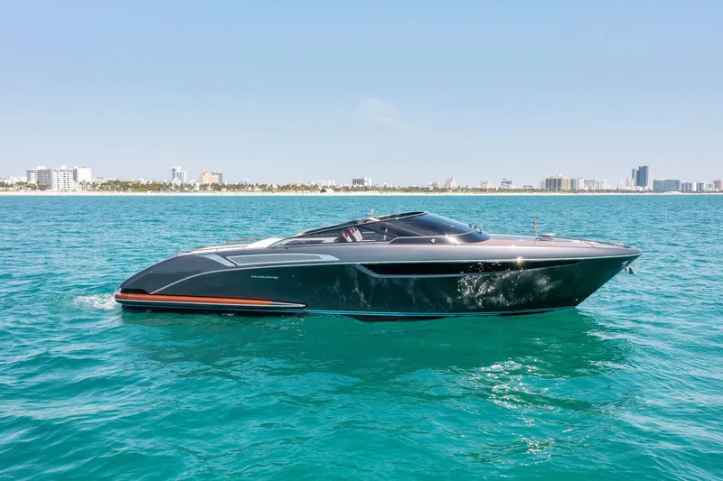 The Image of 2022 Riva 38 Rivamare luxury yacht cruising on clear blue water. - 0