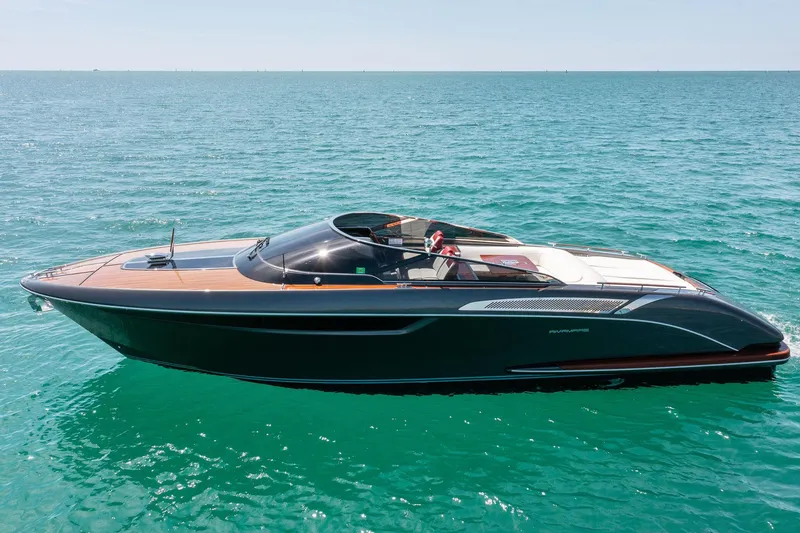 Slide: The Image of 2022 Riva 38 Rivamare luxury yacht cruising on clear blue water. - 1