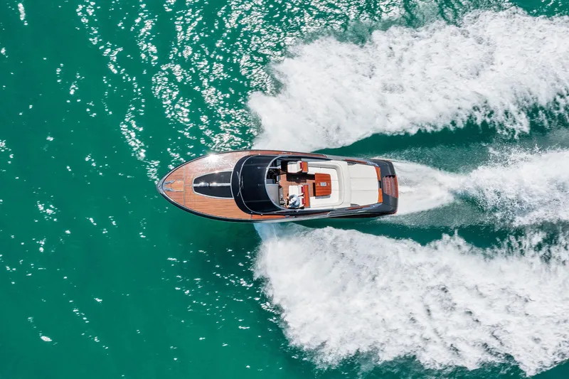 Slide: The Image of Aerial view of a 2022 Riva 38 Rivamare yacht cruising on turquoise waters. - 12