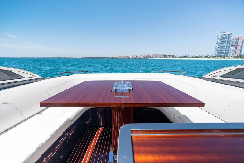 Slide: The Image of Luxury 2022 Riva 38 Rivamare yacht with elegant wooden table and ocean view. - 15