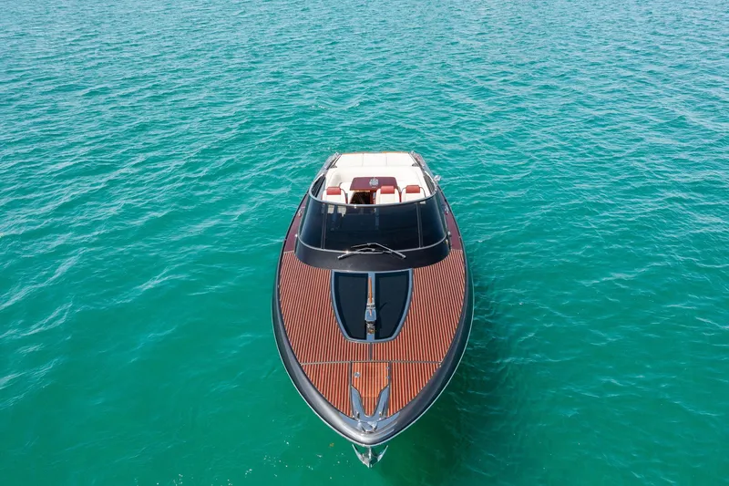 Slide: The Image of 2022 Riva 38 Rivamare luxury yacht on turquoise water. - 2