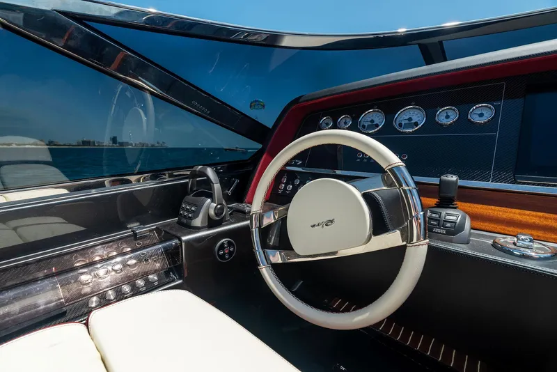 Slide: The Image of Cockpit of 2022 Riva 38 Rivamare luxury yacht with modern steering wheel and dashboard. - 22