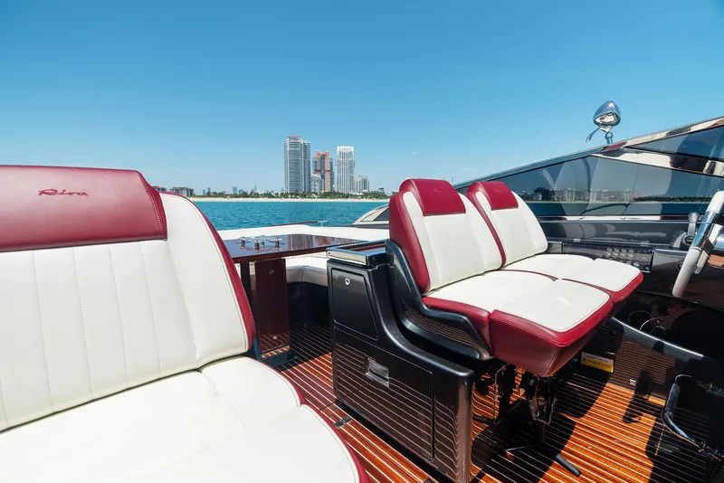Slide: The Image of Luxurious 2022 Riva 38 Rivamare yacht interior with red and white leather seats. - 23
