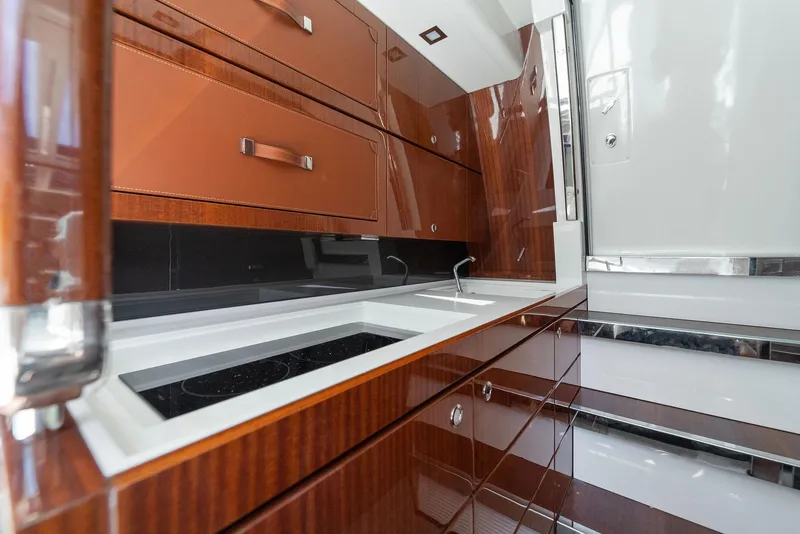 Slide: The Image of Luxurious kitchen area in 2022 Riva 38 Rivamare yacht with sleek wooden cabinetry. - 28