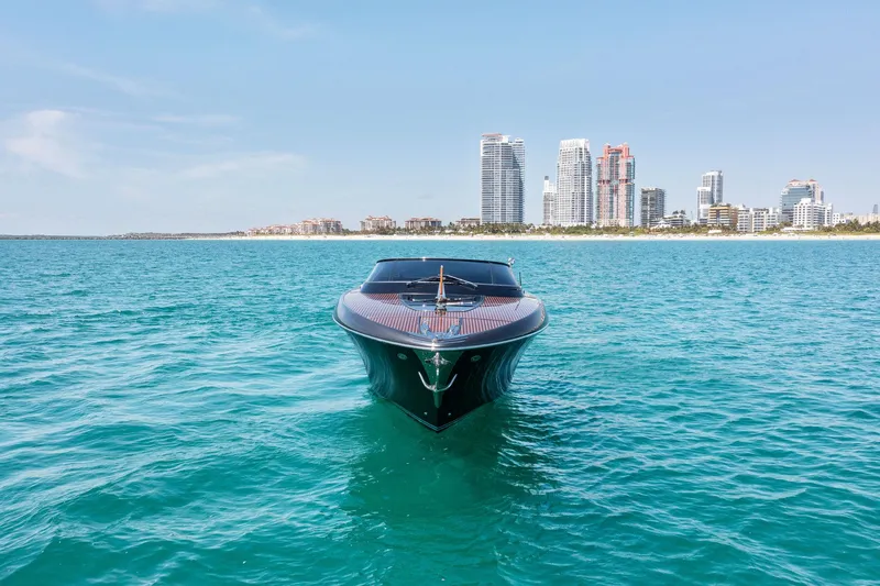 Slide: The Image of 2022 Riva 38 Rivamare yacht on turquoise water with city skyline background. - 3