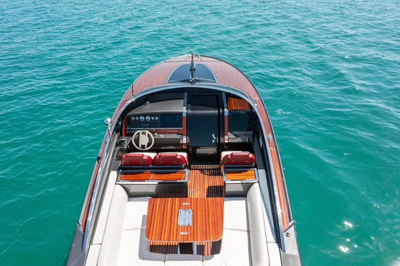 Slide: The Image of 2022 Riva 38 Rivamare luxury yacht on clear blue water. - 4