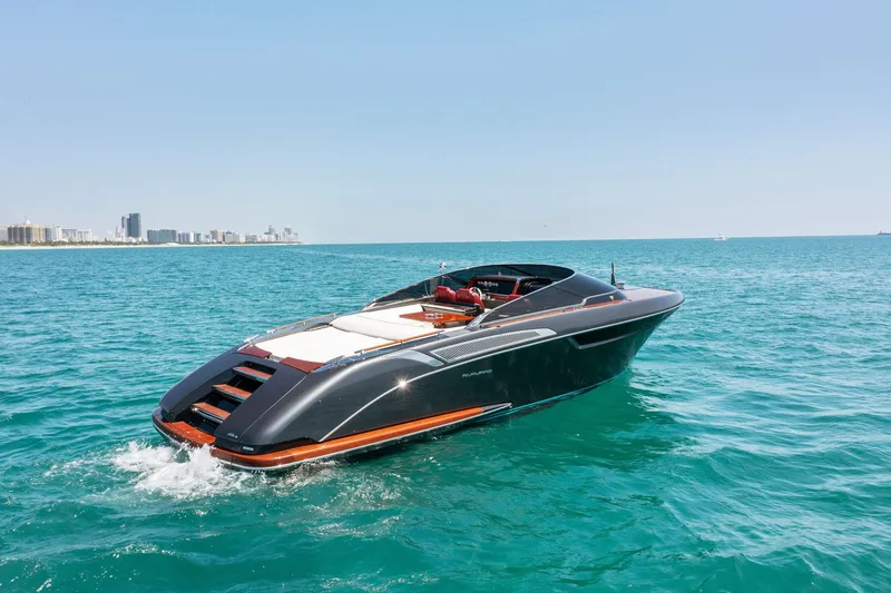 Slide: The Image of 2022 Riva 38 Rivamare luxury yacht cruising on clear blue waters. - 5