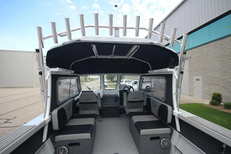 Slide: The Image of 2023 Weldcraft 210 Revolution F200XB Walleye Edition boat interior with seating and rod holders. - 11