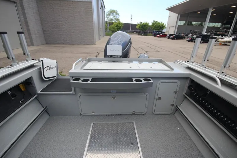 Slide: The Image of 2023 Weldcraft 210 Revolution F200XB Walleye Edition boat interior with fishing rod holders. - 16