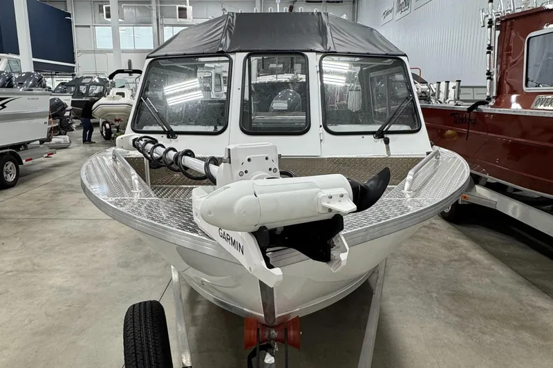 Slide: The Image of 2023 Weldcraft 210 Revolution F200XB Walleye Edition boat in showroom. - 2