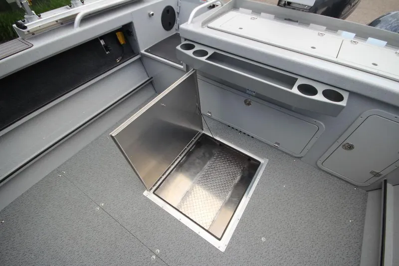 Slide: The Image of 2023 Weldcraft 210 Revolution F200XB Walleye Edition boat interior with open storage compartment. - 21