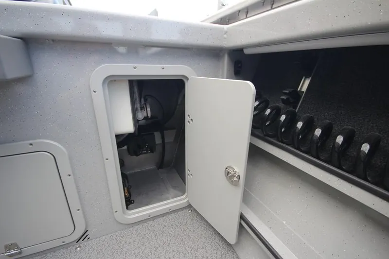 Slide: The Image of 2023 Weldcraft 210 Revolution F200XB Walleye Edition storage compartment and rod holders. - 23