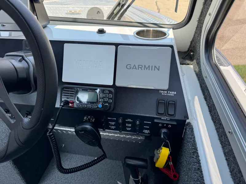 Slide: The Image of 2023 Weldcraft 210 Revolution F200XB Walleye Edition dashboard with Garmin and Yamaha controls. - 26