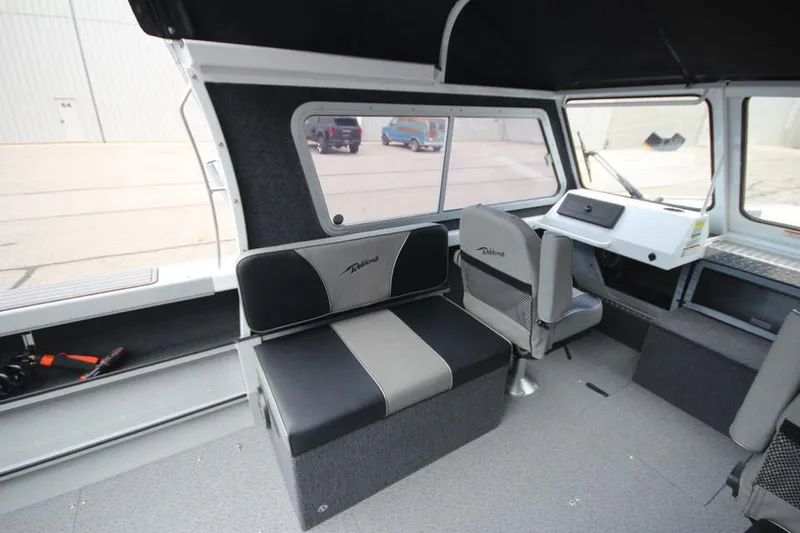 Slide: The Image of 2023 Weldcraft 210 Revolution F200XB Walleye Edition interior with seating and helm station. - 28
