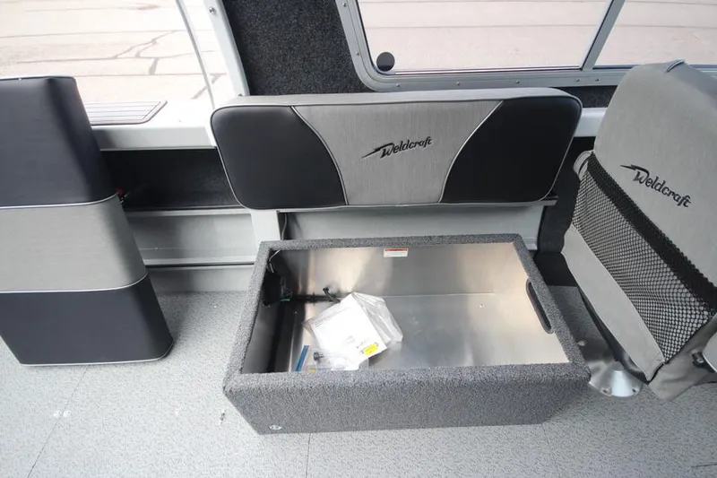 Slide: The Image of 2023 Weldcraft 210 Revolution F200XB Walleye Edition interior storage compartment. - 29