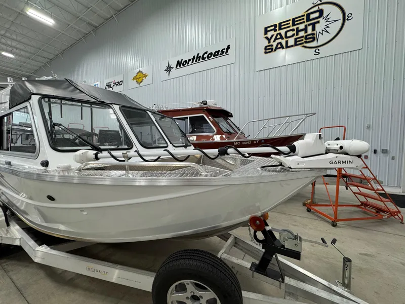 Slide: The Image of 2023 Weldcraft 210 Revolution F200XB Walleye Edition boat in showroom, on trailer. - 3