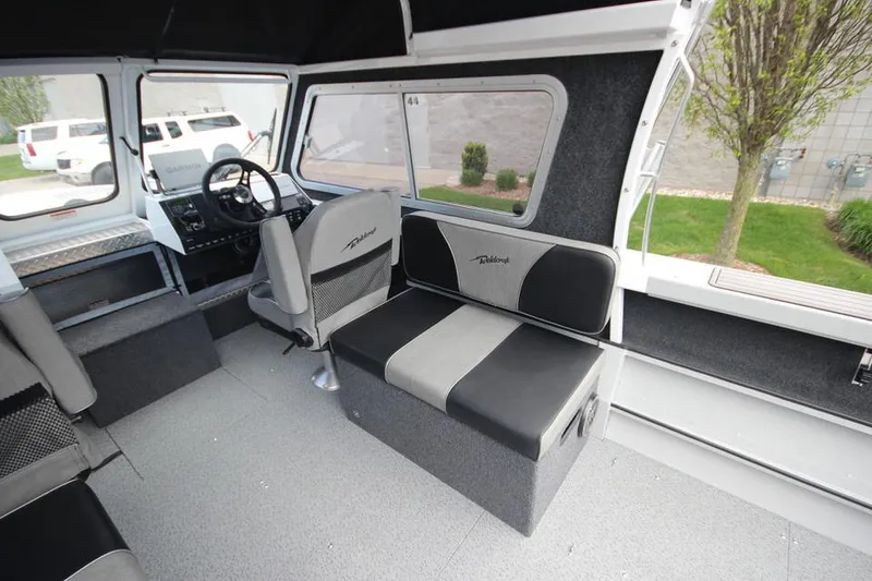 Slide: The Image of 2023 Weldcraft 210 Revolution F200XB Walleye Edition interior with seating and steering console. - 30