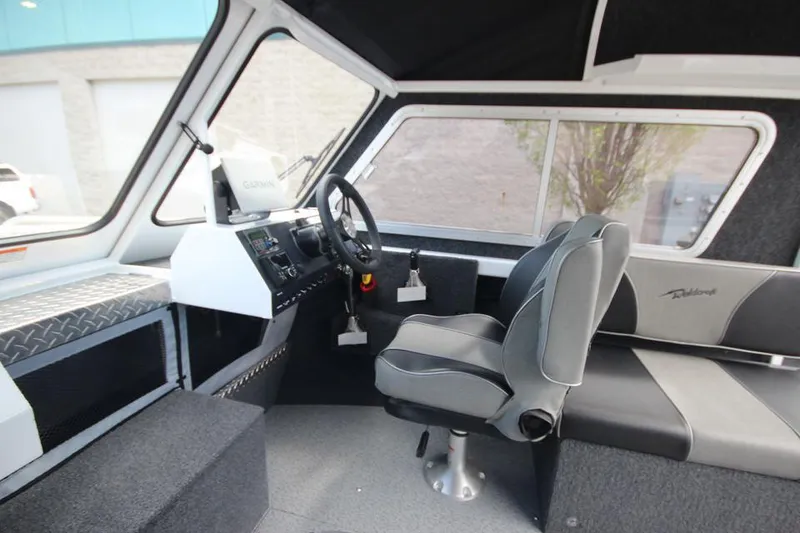 Slide: The Image of 2023 Weldcraft 210 Revolution F200XB Walleye Edition boat interior with steering wheel and seating. - 34