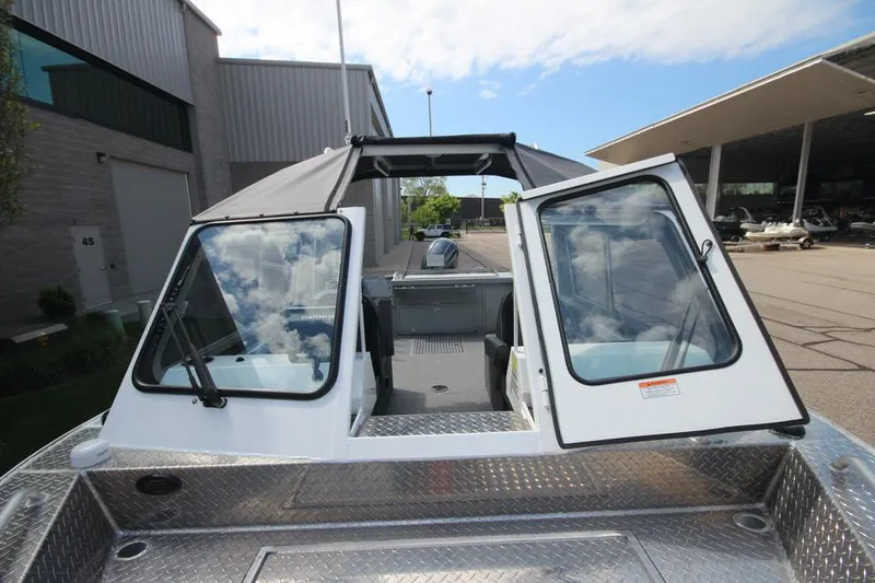 Slide: The Image of 2023 Weldcraft 210 Revolution F200XB Walleye Edition boat with open cabin doors. - 38