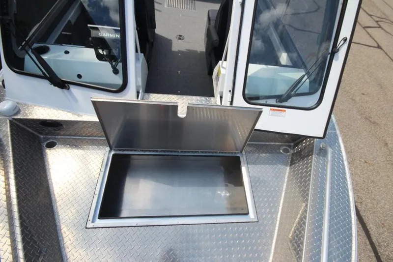 Slide: The Image of 2023 Weldcraft 210 Revolution F200XB Walleye Edition boat with open storage compartment. - 40