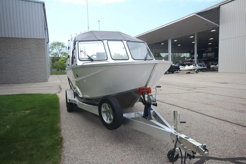 Slide: The Image of 2023 Weldcraft 210 Revolution F200XB Walleye Edition boat on trailer. - 5