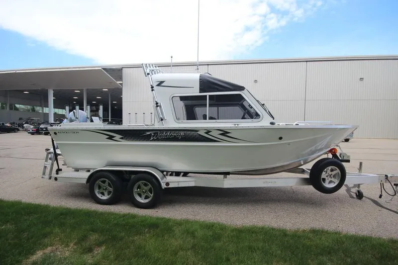 Slide: The Image of 2023 Weldcraft 210 Revolution F200XB Walleye Edition boat on trailer, side view. - 7