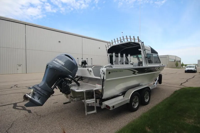 Slide: The Image of 2023 Weldcraft 210 Revolution F200XB Walleye Edition boat on trailer, rear view. - 8